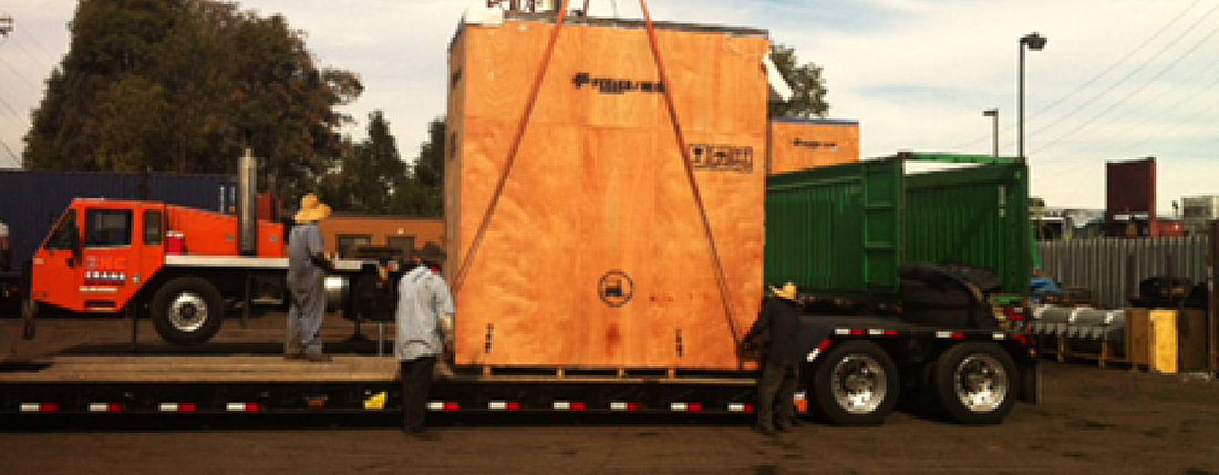 wooden crate being loaded in a trailer truck